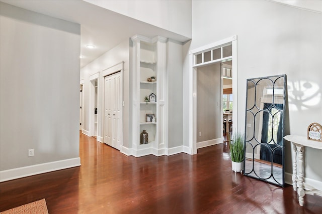 foyer with baseboards and wood finished floors