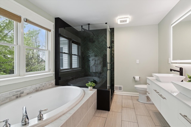9730 Woodbend Dr, Saline, MI 48176 - bathroom featuring toilet, a stall shower, a bath, visible vents, and vanity