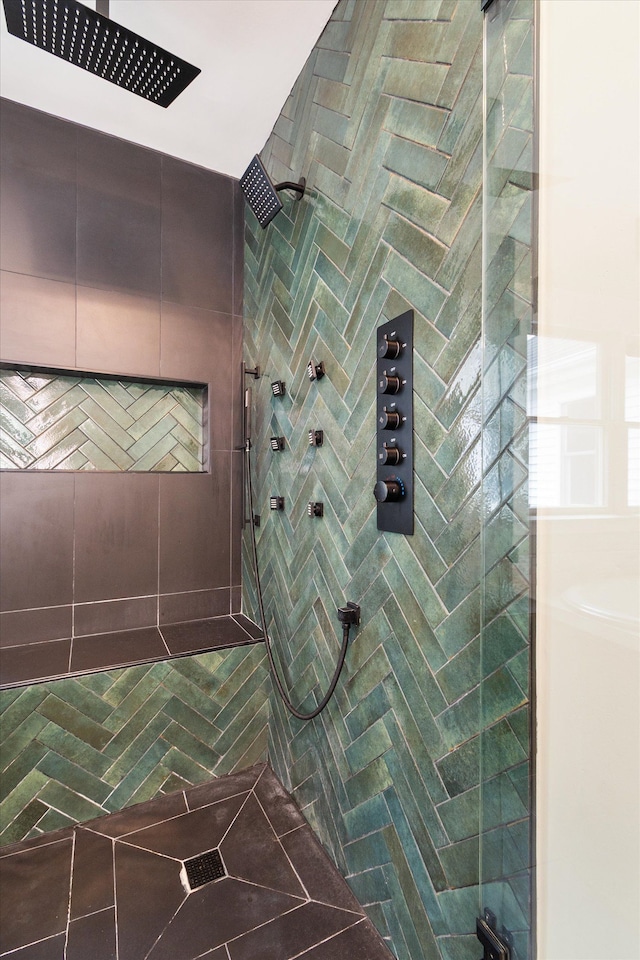 full bath with a tile shower