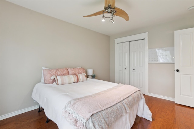 9730 Woodbend Dr, Saline, MI 48176 - bedroom featuring a closet, dark wood finished floors, baseboards, and a ceiling fan