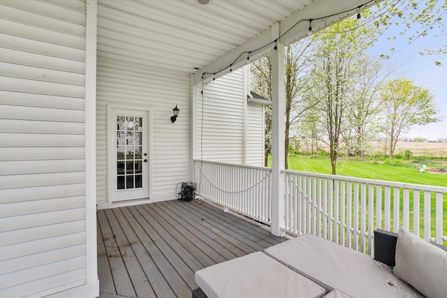 wooden terrace with a yard