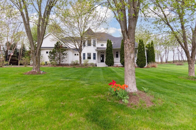 colonial house with roof with shingles and a front lawn