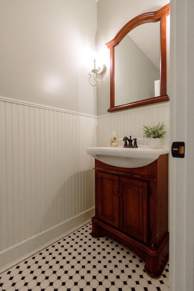 bathroom with a wainscoted wall and vanity