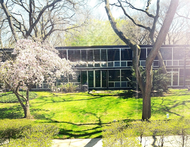 back of property featuring a lawn
