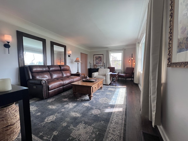 living room with visible vents, ornamental molding, and wood finished floors