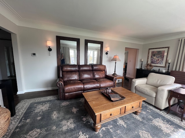 living area with baseboards, ornamental molding, wood finished floors, and visible vents