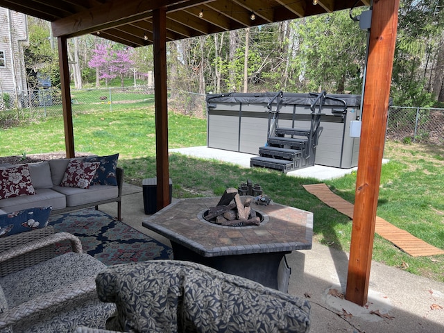 view of patio / terrace with a fenced backyard, an outdoor living space with a fire pit, and a hot tub