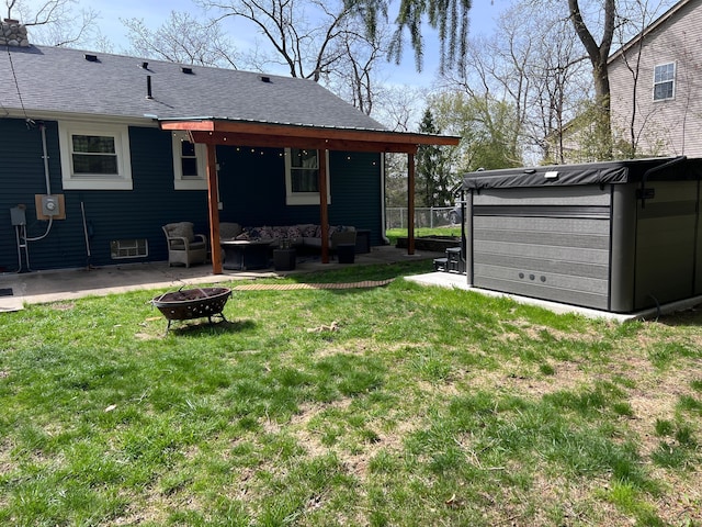 view of yard with a jacuzzi, an outdoor fire pit, and a patio area