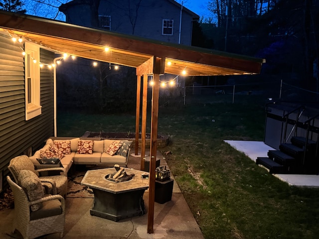 exterior space featuring an outdoor living space with a fire pit and a patio