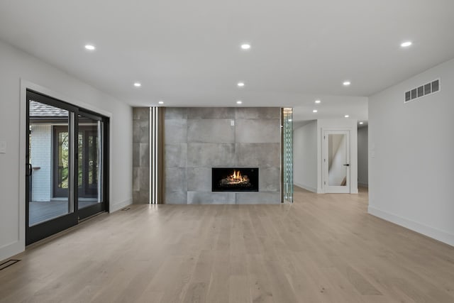 unfurnished living room featuring baseboards, recessed lighting, light wood-style flooring, and visible vents