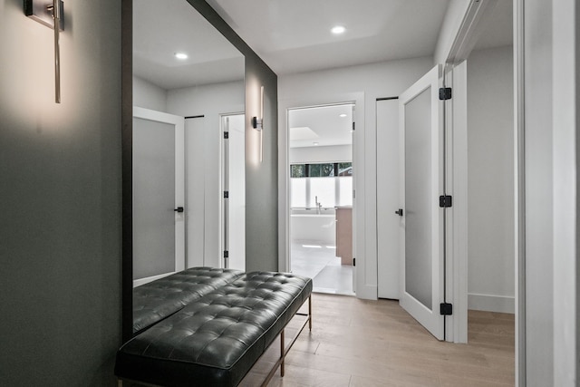 corridor featuring recessed lighting and light wood-type flooring