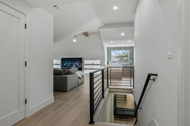 stairs featuring recessed lighting, visible vents, wood finished floors, and vaulted ceiling