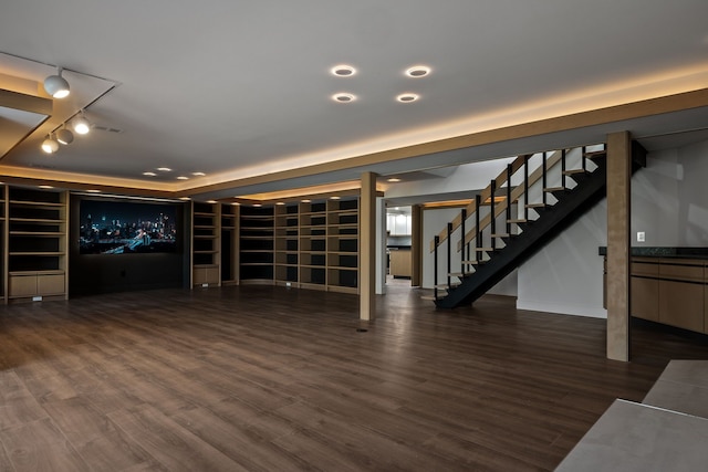 interior space featuring rail lighting, stairs, and wood finished floors