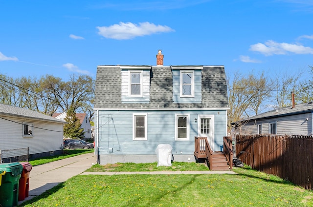 23040 Shakespeare Ave, Eastpointe, MI 48021 - rear view of property featuring fence, a yard, a shingled roof, and a chimney