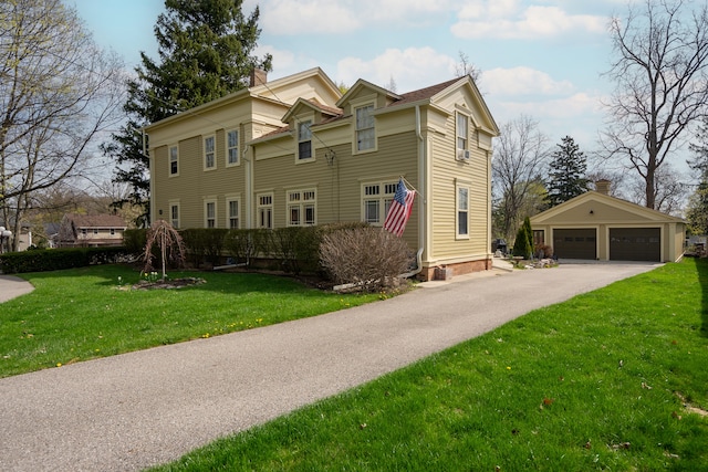 117 Bradley St, Romeo, MI 48065 - view of front of house featuring a chimney, an outdoor structure, a detached garage, and a front yard