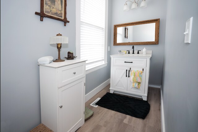 117 Bradley St, Romeo, MI 48065 - bathroom with vanity, wood finished floors, and baseboards