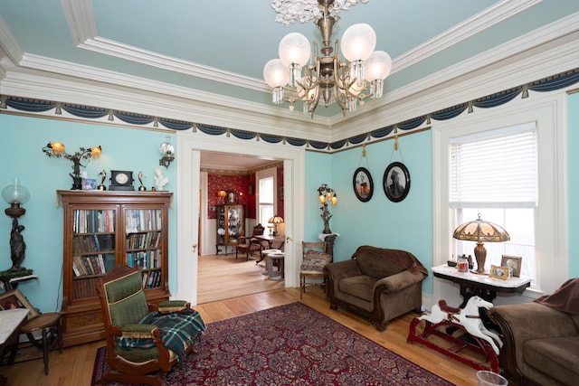 117 Bradley St, Romeo, MI 48065 - living area with ornamental molding, an inviting chandelier, wood finished floors, and plenty of natural light