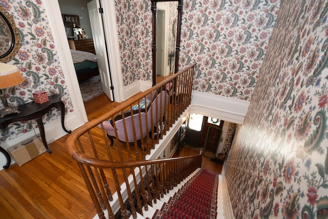117 Bradley St, Romeo, MI 48065 - stairs with baseboards, wallpapered walls, and wood finished floors