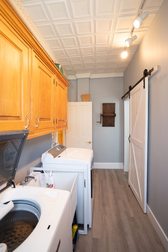 117 Bradley St, Romeo, MI 48065 - clothes washing area with cabinet space, washing machine and dryer, an ornate ceiling, baseboards, and wood finished floors