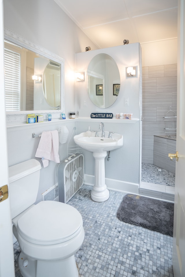 117 Bradley St, Romeo, MI 48065 - bathroom with toilet, a tile shower, and tile patterned flooring