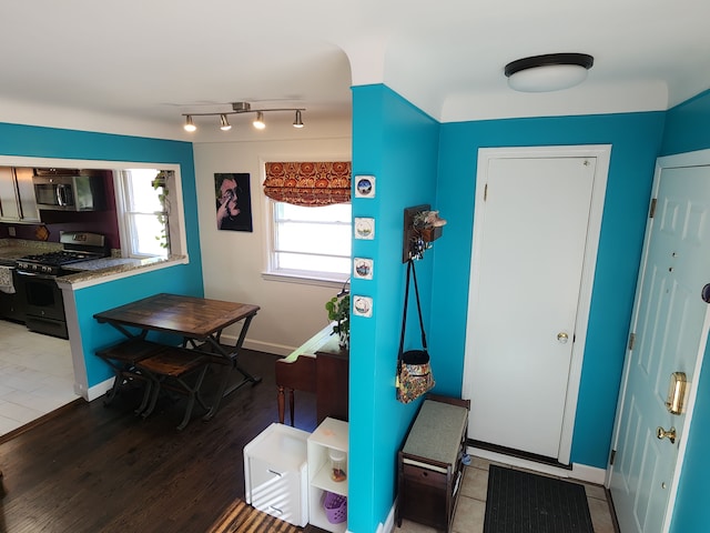 entrance foyer with wood finished floors and baseboards