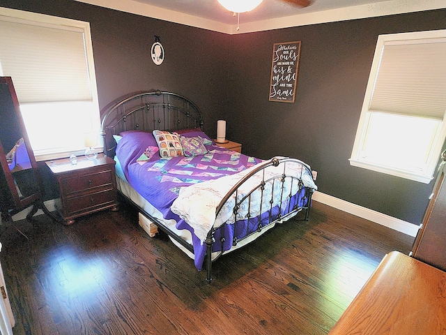 bedroom featuring wood finished floors and baseboards