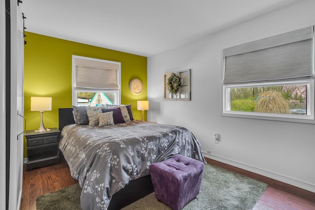 bedroom featuring wood finished floors and baseboards