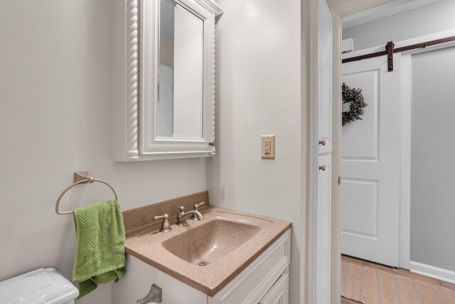 half bathroom featuring toilet and vanity