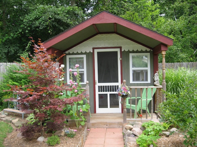 view of outdoor structure with an outbuilding and fence