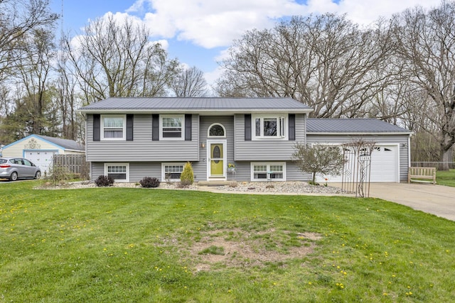 bi-level home featuring metal roof, a front yard, concrete driveway, and a garage