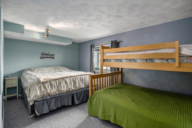 carpeted bedroom featuring a textured ceiling