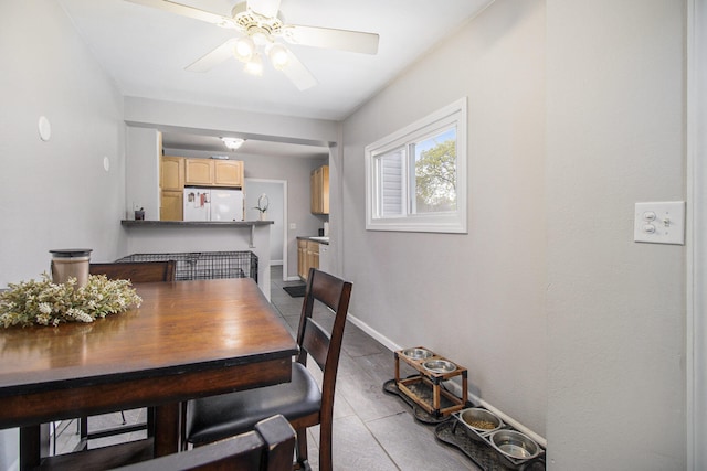 dining room featuring baseboards and a ceiling fan