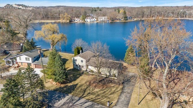 aerial view featuring a water view and a forest view