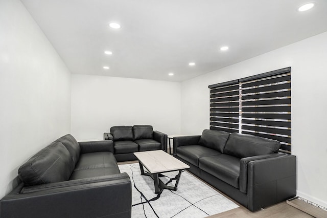 living area with recessed lighting, light wood finished floors, and baseboards