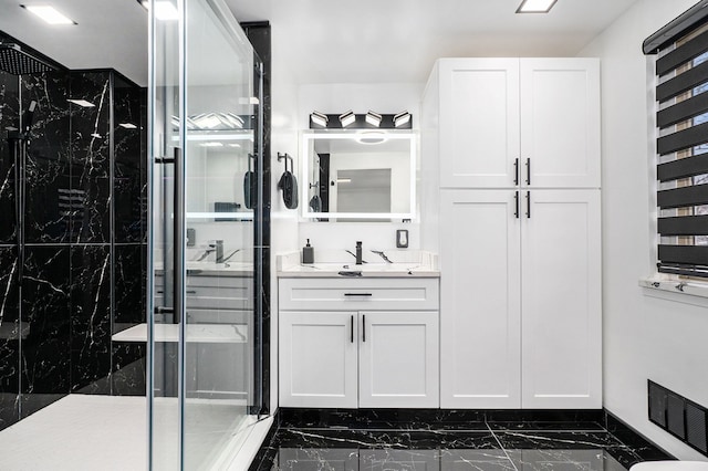 bathroom featuring visible vents, vanity, marble finish floor, and a marble finish shower