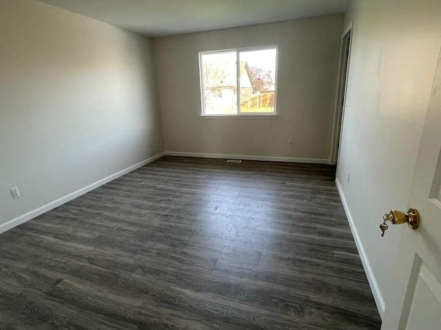 46132 Royal Dr, Chesterfield, MI 48051 - spare room featuring baseboards and dark wood-style floors