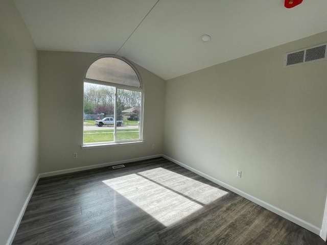 46132 Royal Dr, Chesterfield, MI 48051 - unfurnished room with baseboards, visible vents, dark wood finished floors, and vaulted ceiling