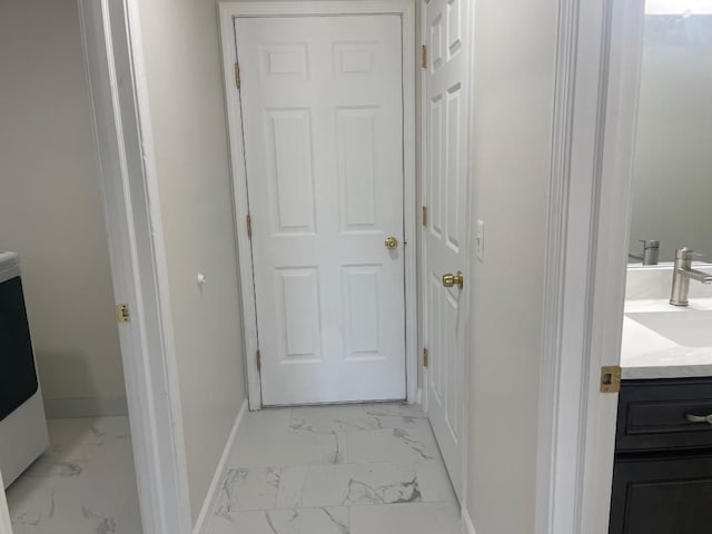 46132 Royal Dr, Chesterfield, MI 48051 - corridor featuring baseboards, a sink, and marble finish floor