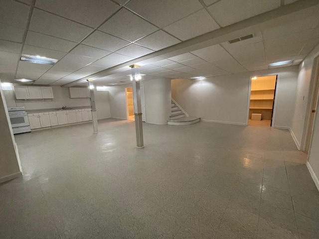 46132 Royal Dr, Chesterfield, MI 48051 - finished basement featuring stairway, baseboards, a paneled ceiling, and visible vents