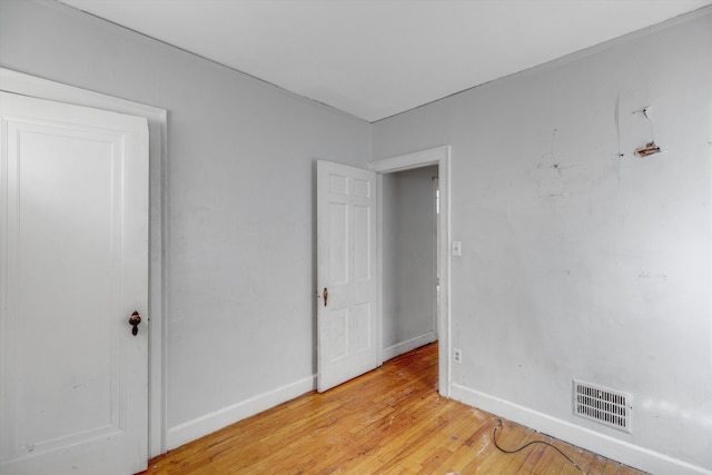 unfurnished bedroom featuring visible vents, light wood-style flooring, and baseboards