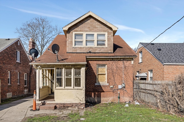 exterior space with fence, a shingled roof, and entry steps