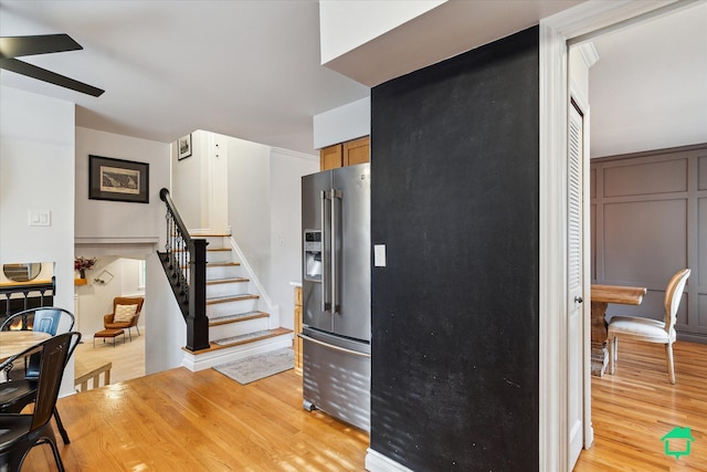 kitchen featuring light wood-style floors, a ceiling fan, and high end fridge
