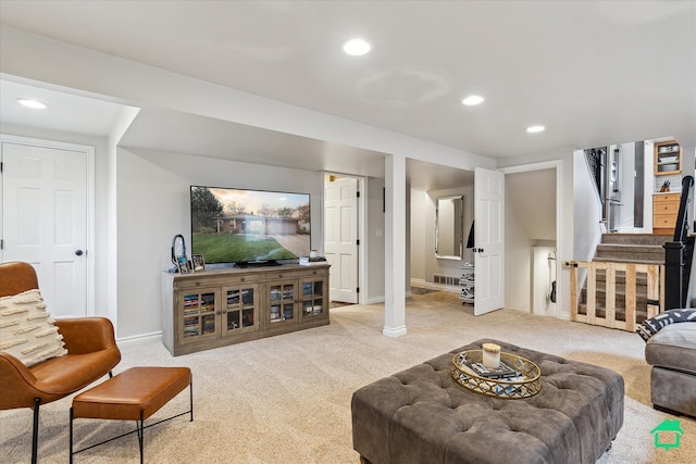carpeted living area with baseboards, recessed lighting, visible vents, and stairs