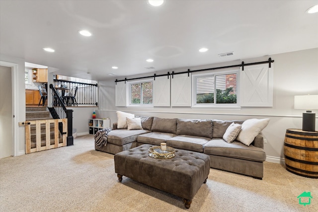 carpeted living room featuring a barn door, recessed lighting, and baseboards