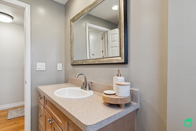 bathroom with wood finished floors and vanity
