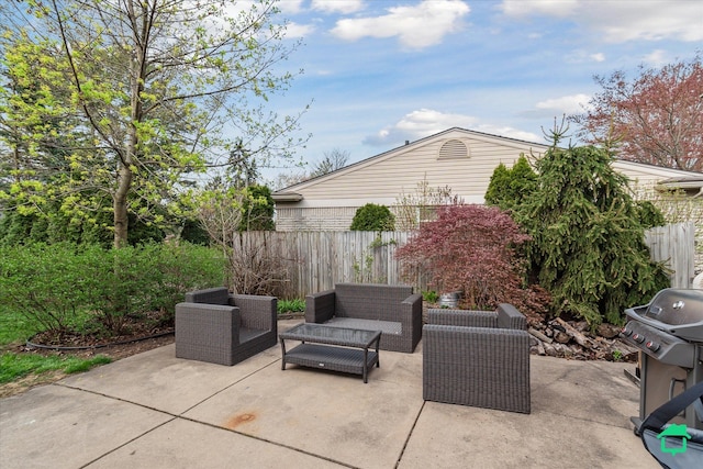 view of patio with outdoor lounge area, fence, and area for grilling