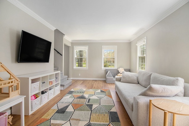 living room with crown molding, light wood-style flooring, and stairway