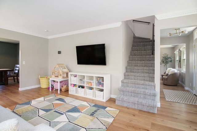 game room with crown molding, baseboards, and wood finished floors