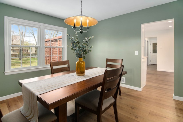 dining room featuring baseboards and light wood-style floors