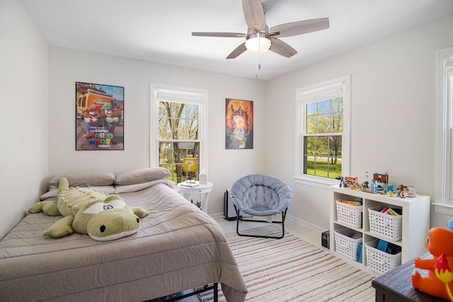 bedroom with baseboards and ceiling fan